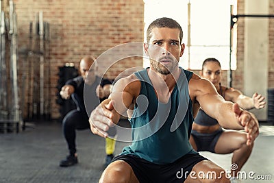 Fitness man squatting with class at gym Stock Photo