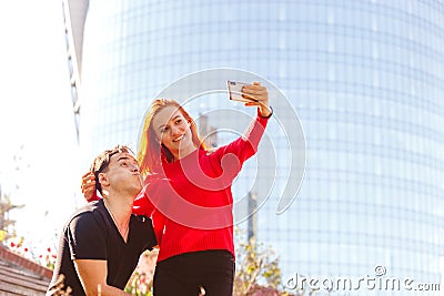 Young man with a girl taking a selfie Stock Photo