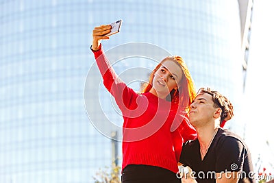 Young man with a girl taking a selfie Stock Photo