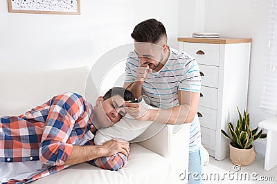 Young man with marker near sleeping friend. April fool`s day Stock Photo