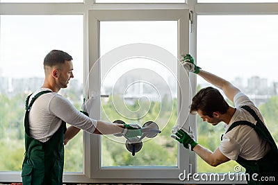 Men mounting a window section Stock Photo