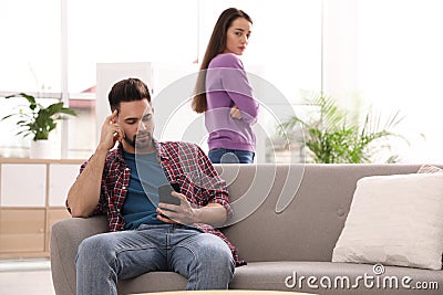 Young man preferring smartphone over his girlfriend Stock Photo