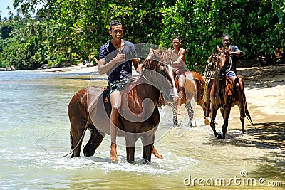 Young men riding horses on the beach on Taveuni Island, Fiji Editorial Stock Photo