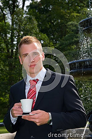 Young men in suit with a cup Stock Photo