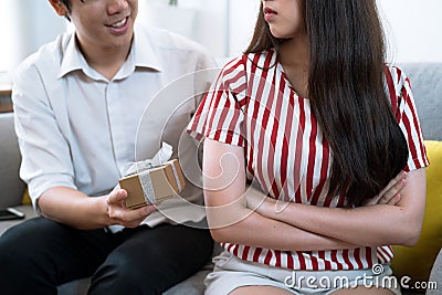 Man tried to reconcile with his girlfriend and he gave her a gift box to make her feel better. Stock Photo