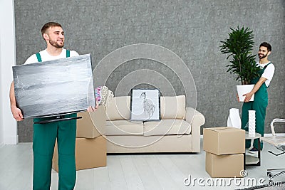 Young men in uniform working. Moving service Stock Photo