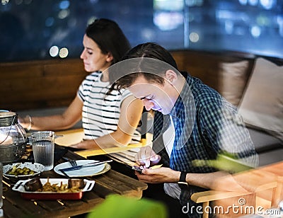 Young man using a smartphone with no social interaction addiction concept Stock Photo