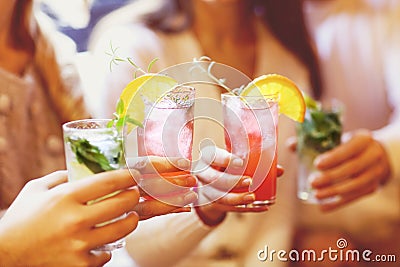 Young men and women drinking cocktail at party Stock Photo