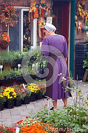 A young Mennonite woman shops for garden flowers Editorial Stock Photo