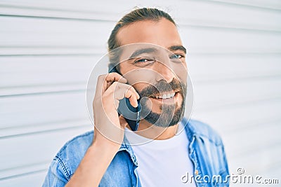 Young middle eastern man talking on the smartphone at the city Stock Photo