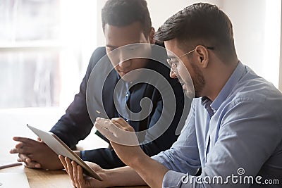 Diverse millennial employees discussing data report at office Stock Photo