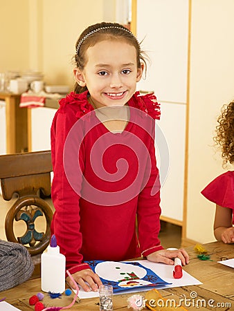 Young mixed race child making Christmas cards Stock Photo