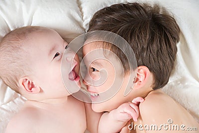 Mixed Race Chinese and Caucasian Baby Brothers Having Fun Laying Stock Photo