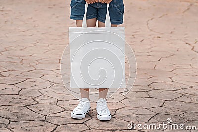 young model holding white tote bag for mockup blank template Stock Photo