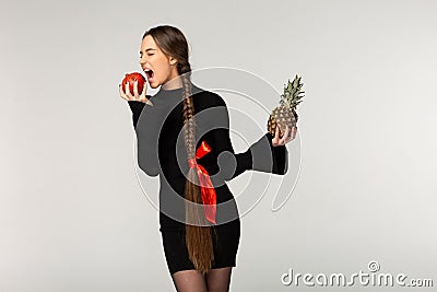 Young model with long braid and red bow wearing black dress Stock Photo