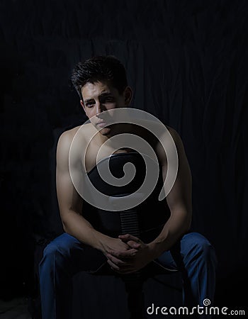 Young model sitting and with a lighting scheme rembrandt. Stock Photo