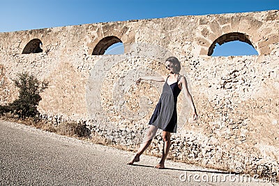 Young model wearing sunglasses and summer clothes dancing Stock Photo