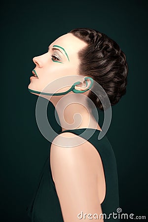 Young modern woman with green avantgarde make up and beautiful hair style Stock Photo