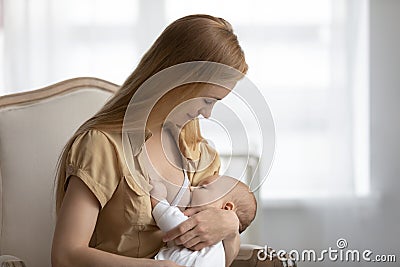 Young mom breastfeed little newborn child at home Stock Photo