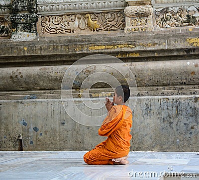A young monk praying at the Buddhist temple in Delhi, India Editorial Stock Photo