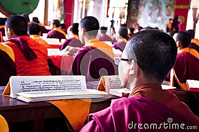 Young tibetan monk reading buddhist religious text Editorial Stock Photo