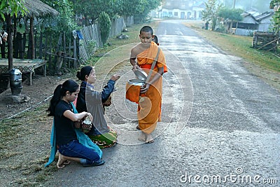Young Monks collecting alms Editorial Stock Photo