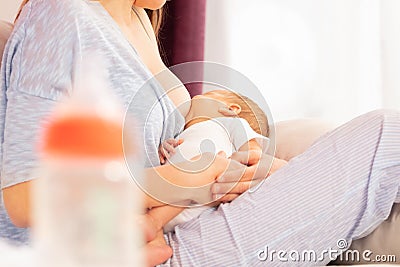 Young mother breastfeed newborn baby with breast Stock Photo