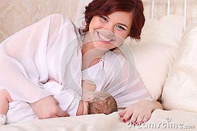 Young mother breastfeeds her baby Stock Photo