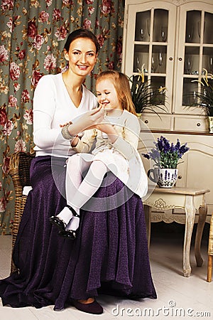 Young mother with daughter at luxury home interior vintage Stock Photo