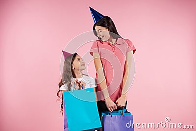 Young mother and daughter in party caps Stock Photo