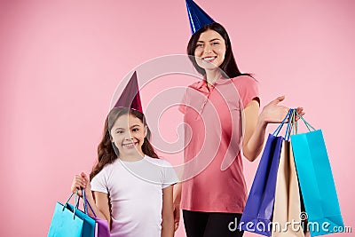 Young mother and daughter in party caps Stock Photo