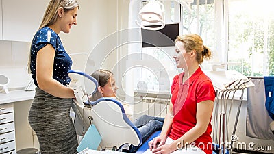 Young mother with daughter visiting dentist office for checkup Stock Photo