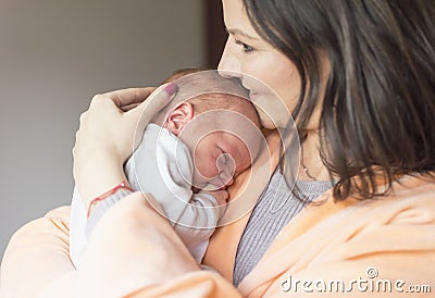 Woman holding a newborn baby in her arms Stock Photo