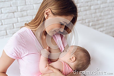 Young mother feeding breast baby. Stock Photo