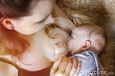 A young mother feeds the baby. breast feeding. health. food. immunity Stock Photo