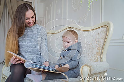 Mother and her baby son looking photobook Stock Photo