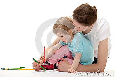 Young mother and her daughter drawing together Stock Photo