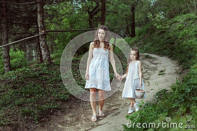 Young mother with her daughter in the woods Stock Photo