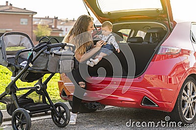 mother with her son behind the car preparing the trip Stock Photo