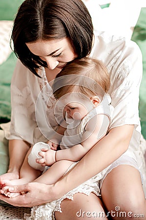 A young mother holds a small daughter in her arms Stock Photo