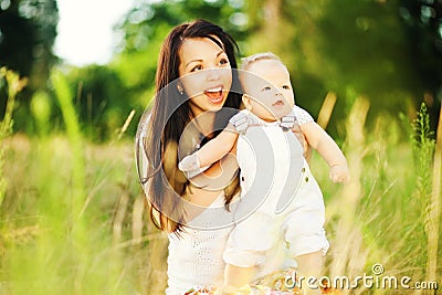 Young mother with infant baby outdoors Stock Photo