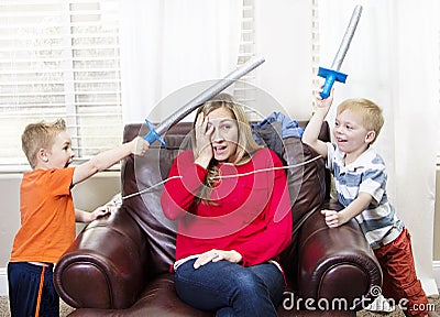 Young Mother overwhelmed by her kids Stock Photo