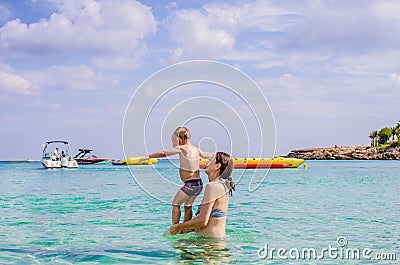 Young mother plays with her young son in the sea Stock Photo