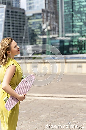 Young mother practising on skateboard Stock Photo