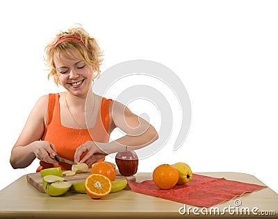 Young mother preparing fruit salad Stock Photo