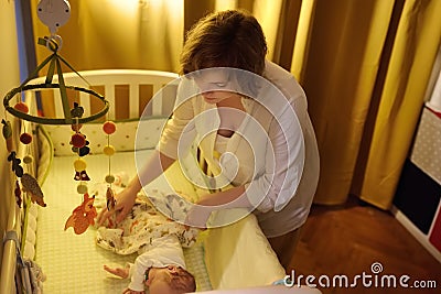 Young mother puts the baby to sleep Stock Photo