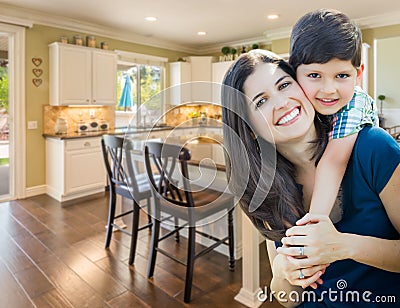 Young Mother and Son Inside Beautiful Custom Kitchen. Stock Photo