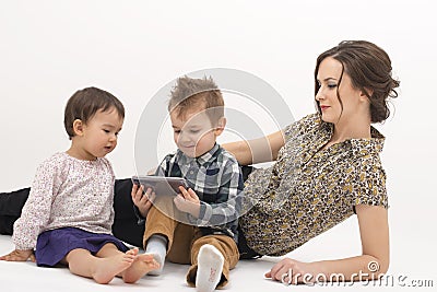 Young mother with two children watching cartoons on cell phone Stock Photo