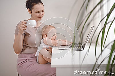 Young mother work studying from home with laptop computer during quarantine, little cute toddler baby on lap. Home office, Stock Photo