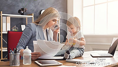 Young mother working and spending time with baby Stock Photo